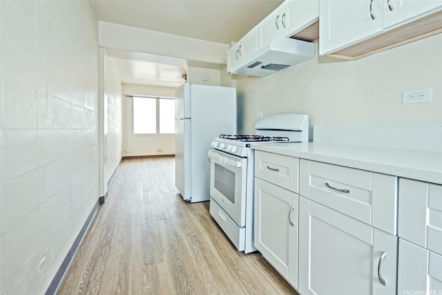 kitchen featuring light wood-style floors, white appliances, white cabinetry, under cabinet range hood, and light countertops