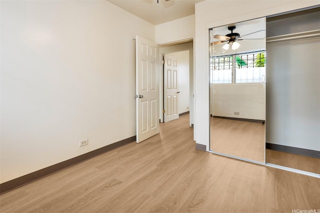 unfurnished bedroom featuring a closet, light wood-style flooring, ceiling fan, and baseboards