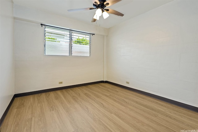 unfurnished room featuring baseboards, a ceiling fan, and wood finished floors