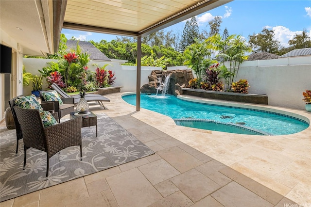 view of pool featuring a fenced backyard, a patio area, and a pool with connected hot tub