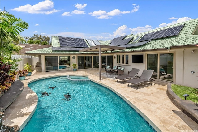 view of swimming pool with a patio area, a pool with connected hot tub, and a fenced backyard