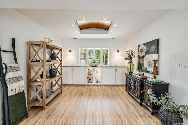 interior space with light wood-style flooring and a tray ceiling