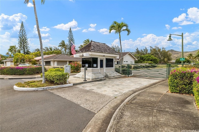 bungalow-style house featuring a gate and stucco siding
