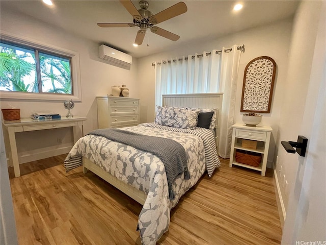 bedroom with recessed lighting, an AC wall unit, a ceiling fan, light wood-type flooring, and baseboards