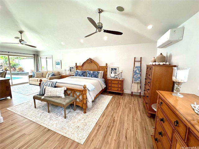 bedroom featuring an AC wall unit, lofted ceiling, access to exterior, and light wood finished floors