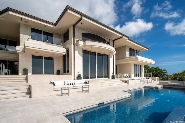 360 Puuikena Dr, Honolulu, HI 96821 - rear view of property featuring a patio area, a pool with connected hot tub, and a balcony