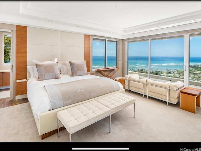360 Puuikena Dr, Honolulu, HI 96821 - bedroom featuring a tray ceiling, recessed lighting, multiple windows, and a water view