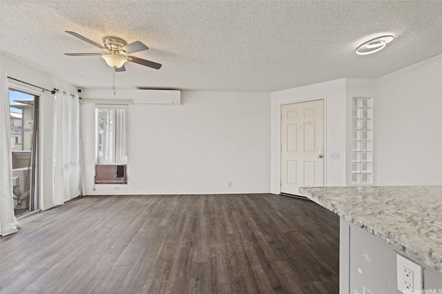 unfurnished living room with dark wood-style floors, cooling unit, a wall mounted AC, a textured ceiling, and ceiling fan