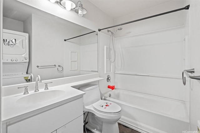 bathroom with toilet, stacked washing maching and dryer, vanity, and shower / washtub combination