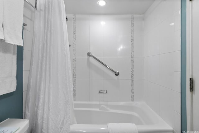 bathroom featuring recessed lighting and shower / tub combo