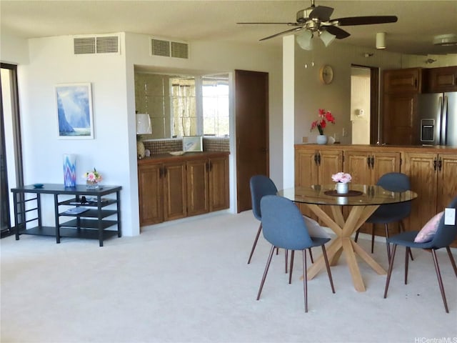 555 Hahaione St Unit 12D, Honolulu, HI 96825 - dining area featuring ceiling fan, visible vents, and light colored carpet
