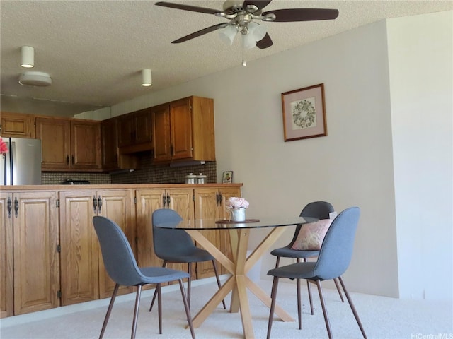 555 Hahaione St Unit 12D, Honolulu, HI 96825 - kitchen with light carpet, a textured ceiling, and freestanding refrigerator