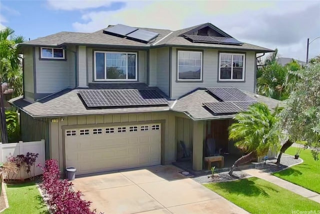 91-1154 Pekau St, Ewa Beach, HI 96706 - view of front of house featuring solar panels, a garage, driveway, and roof with shingles