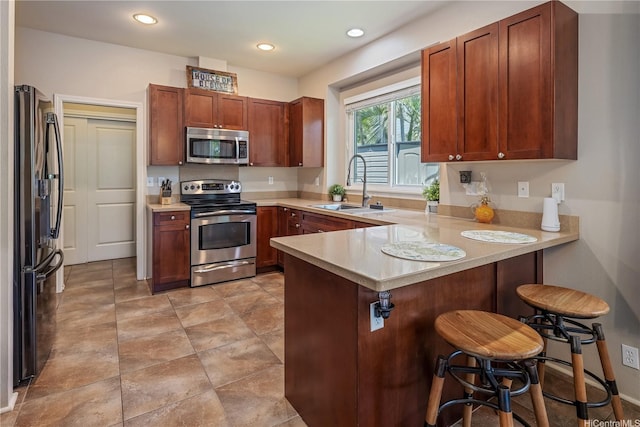 91-1154 Pekau St, Ewa Beach, HI 96706 - kitchen with appliances with stainless steel finishes, a sink, a peninsula, light countertops, and a kitchen breakfast bar