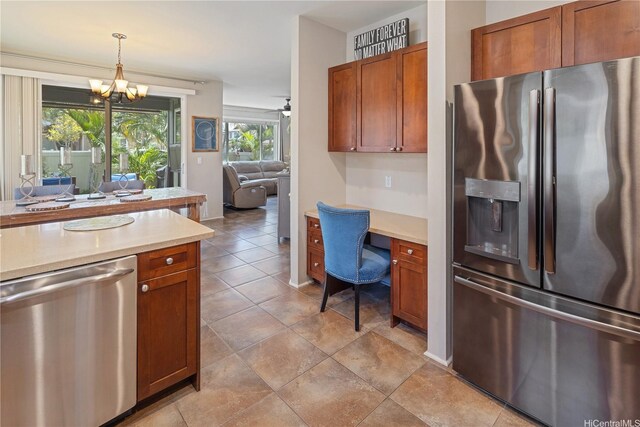 91-1154 Pekau St, Ewa Beach, HI 96706 - kitchen with appliances with stainless steel finishes, light countertops, a chandelier, brown cabinets, and decorative light fixtures
