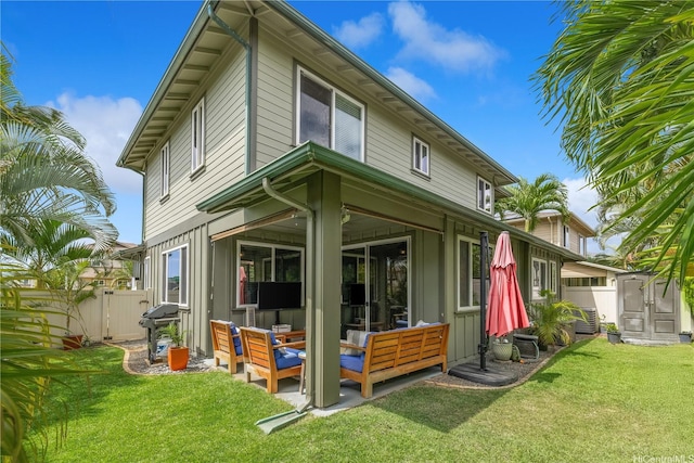 91-1154 Pekau St, Ewa Beach, HI 96706 - rear view of house with an outdoor hangout area, board and batten siding, and a storage unit