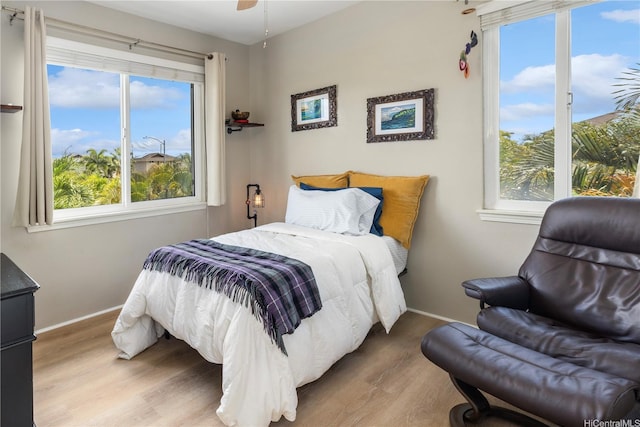 91-1154 Pekau St, Ewa Beach, HI 96706 - bedroom with wood finished floors, multiple windows, and baseboards