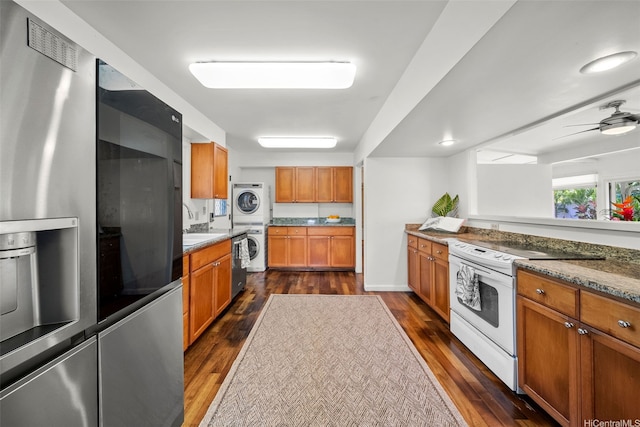 248 Aikane St, Kailua, HI 96734 - kitchen featuring stacked washing machine and dryer, white range with electric cooktop, stainless steel fridge, dark wood finished floors, and brown cabinets