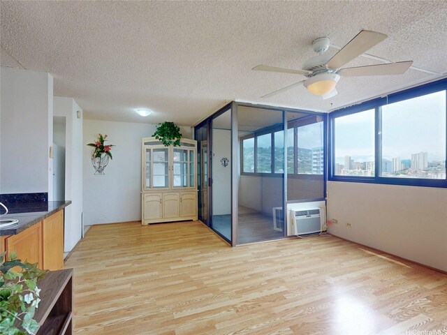 1571 Piikoi St Unit 1601, Honolulu, HI 96822 - interior space featuring light wood-style flooring, a textured ceiling, and ceiling fan