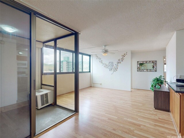 1571 Piikoi St Unit 1601, Honolulu, HI 96822 - interior space featuring light wood-style flooring, a textured ceiling, and a ceiling fan