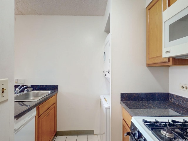 1571 Piikoi St Unit 1601, Honolulu, HI 96822 - kitchen featuring dark countertops, a sink, white appliances, and light tile patterned floors