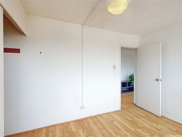 1571 Piikoi St Unit 1601, Honolulu, HI 96822 - unfurnished room with light wood-style flooring and a textured ceiling
