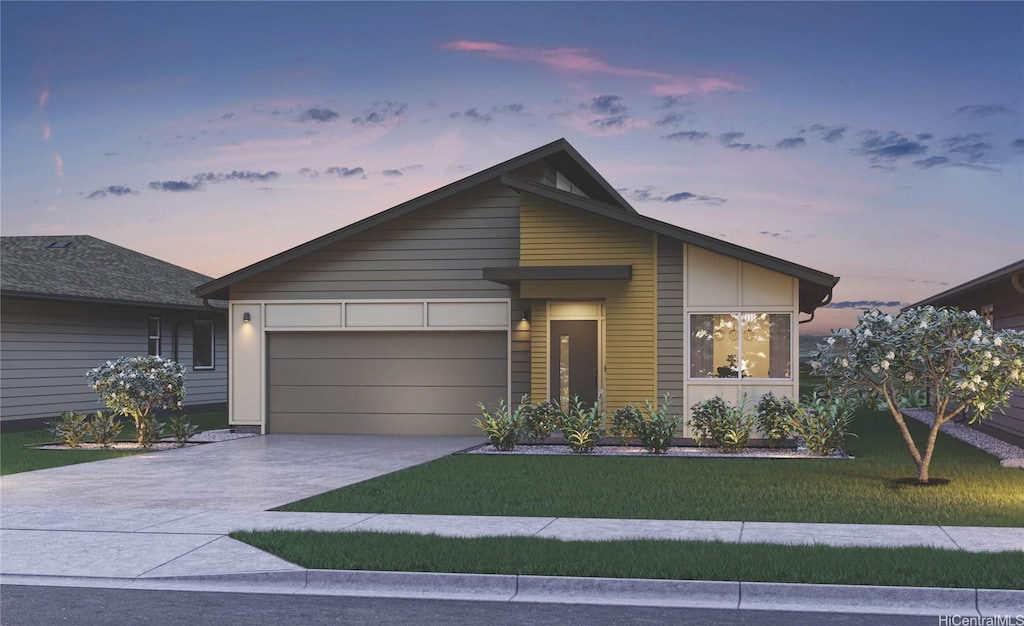 contemporary house featuring a garage, concrete driveway, and a front yard
