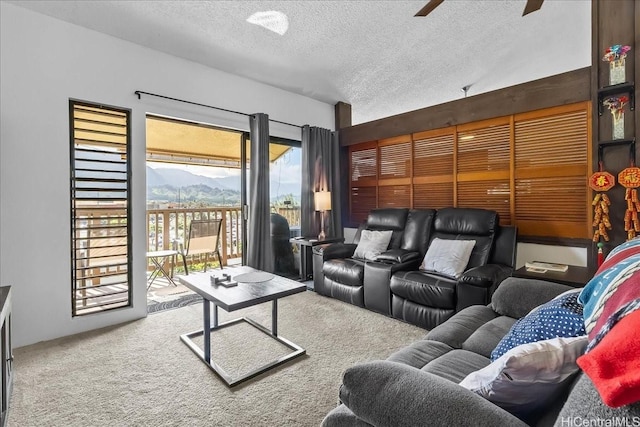 46-020 Aliikane Pl Unit 325, Kaneohe, HI 96744 - carpeted living room featuring a mountain view, ceiling fan, and a textured ceiling