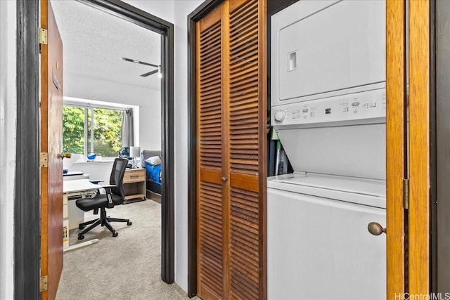 46-020 Aliikane Pl Unit 325, Kaneohe, HI 96744 - washroom with stacked washer and dryer, carpet floors, laundry area, and a textured ceiling