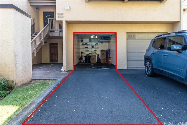 46-020 Aliikane Pl Unit 325, Kaneohe, HI 96744 - entrance to property with a garage, stucco siding, and driveway
