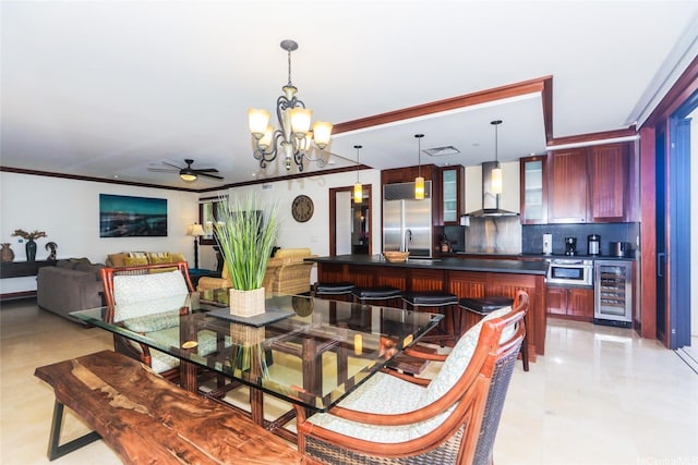 dining area featuring ceiling fan with notable chandelier, wine cooler, visible vents, and ornamental molding