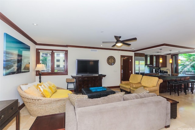 living area featuring ceiling fan, baseboards, ornamental molding, visible vents, and recessed lighting