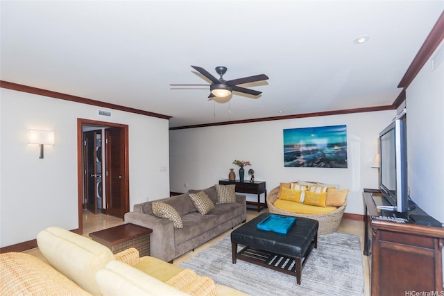 living area with crown molding, visible vents, a ceiling fan, and baseboards