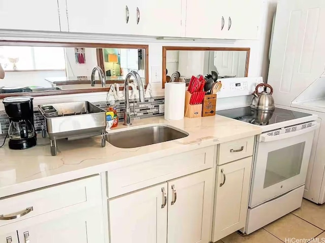 410 Nahua St Unit 212, Honolulu, HI 96815 - kitchen with light stone counters, white range with electric stovetop, a sink, decorative backsplash, and white cabinetry