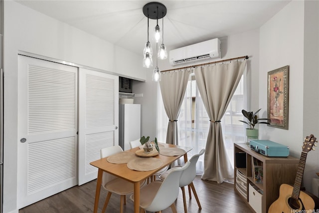 dining space with dark wood finished floors and a wall mounted AC