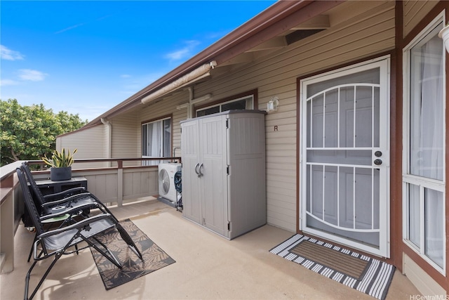 view of patio with washer and clothes dryer and a balcony