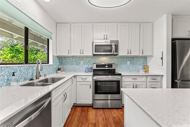 kitchen with white cabinets, appliances with stainless steel finishes, and a sink
