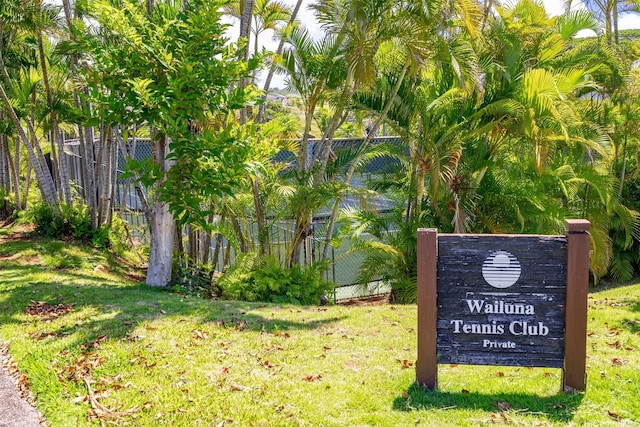 surrounding community with a lawn and fence