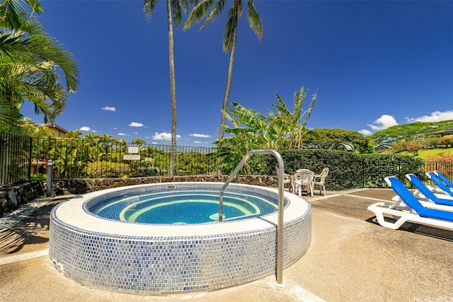 view of pool with fence, a patio area, and a community hot tub