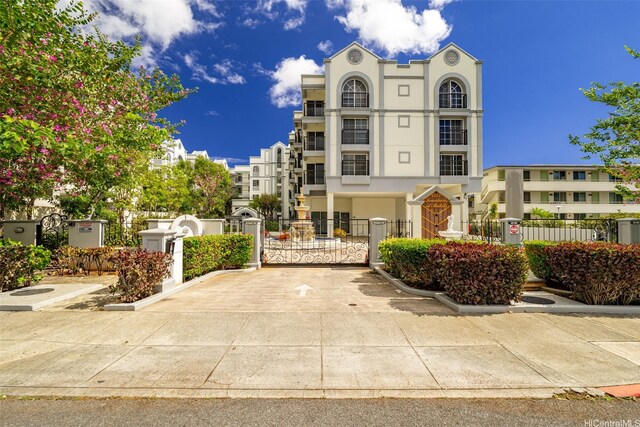 1433 Kewalo St Unit Ph12, Honolulu, HI 96822 - view of front of home with stucco siding, fence, and a gate
