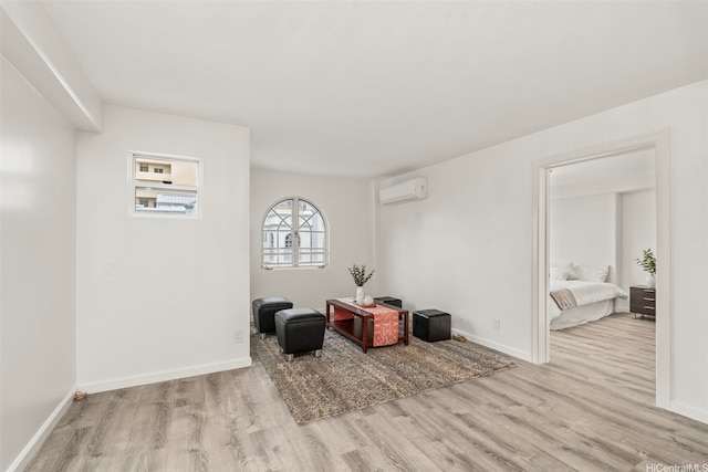 1433 Kewalo St Unit Ph12, Honolulu, HI 96822 - sitting room featuring baseboards, wood finished floors, and a wall mounted air conditioner