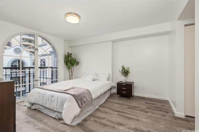 1433 Kewalo St Unit Ph12, Honolulu, HI 96822 - bedroom featuring french doors, access to exterior, baseboards, and wood finished floors
