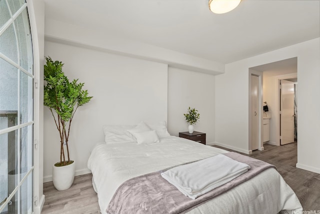 1433 Kewalo St Unit Ph12, Honolulu, HI 96822 - bedroom featuring baseboards and wood finished floors
