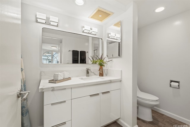 1433 Kewalo St Unit Ph12, Honolulu, HI 96822 - bathroom with vanity, baseboards, toilet, visible vents, and wood finished floors