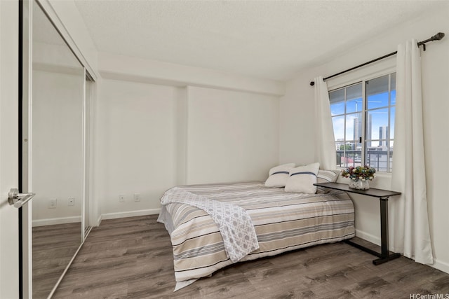 1433 Kewalo St Unit Ph12, Honolulu, HI 96822 - bedroom featuring dark wood-style flooring and baseboards
