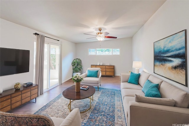 living room featuring wood finished floors, a ceiling fan, and plenty of natural light