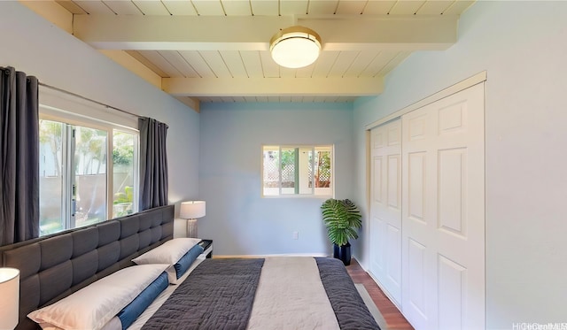 interior space featuring wood finished floors, beamed ceiling, and a wealth of natural light