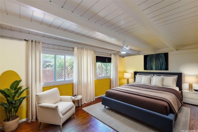 bedroom with beamed ceiling, baseboards, wood finished floors, and wood ceiling