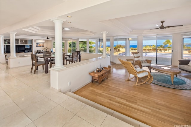 31 Poipu Dr, Honolulu, HI 96825 - living area with a tray ceiling, ornate columns, ceiling fan, and light tile patterned floors