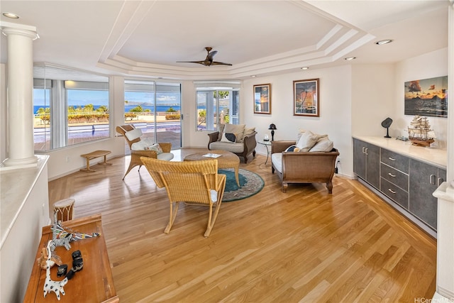 31 Poipu Dr, Honolulu, HI 96825 - interior space featuring ceiling fan, a tray ceiling, light wood-style flooring, baseboards, and ornate columns